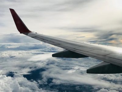 pexels-photo-1687633 A stunning aerial view of fluffy clouds and an airplane wing during daylight flying.